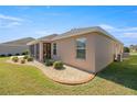 House exterior with screened patio and well-manicured lawn at 3775 Raspberry Ct, The Villages, FL 32163