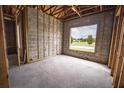 Under construction bedroom featuring a large window and framing at 10619 Grand Oaks Blvd, Oxford, FL 34484