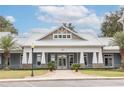 Community clubhouse with gray exterior and stone accents at 10607 Grand Oaks Blvd, Oxford, FL 34484