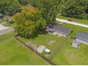 Aerial view showcasing large backyard with storage shed and surrounding trees at 3610 Se 140Th Pl, Summerfield, FL 34491