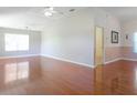Living room with hardwood floors and ceiling fan at 21701 Queen Mary Ct, Leesburg, FL 34748
