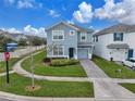 Two-story house situated on a quiet residential street at 1592 Flange Dr, Davenport, FL 33896