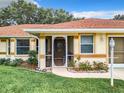 Enclosed front porch with seating and entrance at 5430 Sir Churchill Dr, Leesburg, FL 34748