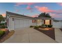 Well-maintained house with a screened garage and landscaped yard at 8457 Se 177Th Penman Pl, The Villages, FL 32162