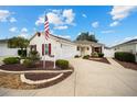 Single-story home with a two-car garage and landscaped yard at 8457 Se 177Th Penman Pl, The Villages, FL 32162