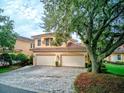 Two-story Mediterranean home with three-car garage and paved driveway at 44 Camino Real Blvd # 44, Howey In The Hills, FL 34737