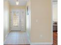 Bright entryway with tile flooring and a glass-paneled front door at 404 Simpson St, The Villages, FL 32162