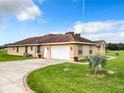 House exterior with attached garage and large yard at 275 Cr 552, Bushnell, FL 33513