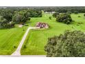Aerial view of a house on a large lot with lush greenery at 275 Cr 552, Bushnell, FL 33513