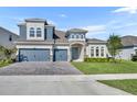 Two-story house with a three-car garage and landscaped lawn at 4495 Lions Gate Ave, Clermont, FL 34711