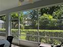 Peaceful screened patio offering backyard views and plenty of natural light at 2277 Calvert Ct, Clermont, FL 34711