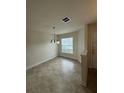 Simple dining area with tile floors, light walls, and a chandelier at 608 Bradley Way, Fruitland Park, FL 34731