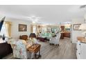 Open living room with tile floors and view into the kitchen at 2403 Carriage Hill Way, The Villages, FL 32162