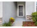 Inviting front door entrance with stone accents and landscaping at 15812 Surfbird Ct, Mascotte, FL 34753