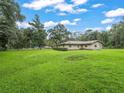 Ranch home with a spacious lawn and lush landscaping at 10166 Cr 671, Bushnell, FL 33513