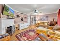 Living room featuring a fireplace, hardwood floors, and comfortable seating at 70 N Oak Ave, Umatilla, FL 32784