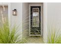 Front entry with dark door and sidelights, flanked by greenery at 1073 River Otter Way, Deland, FL 32720