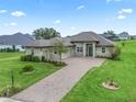 House exterior featuring a large lawn and driveway at 5159 Greens Dr, Lady Lake, FL 32159