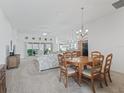 Open dining area with a wooden table, chairs, and view to living room at 3240 Lafayette St, The Villages, FL 32163