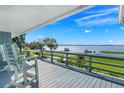 Lakefront deck with white chairs overlooking the water at 11329 Lake Minneola Shrs, Minneola, FL 34715