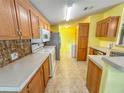 Kitchen with wood cabinets, tiled floors, and a breakfast bar at 1660 Elkhart Cir, Tavares, FL 32778