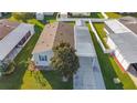 Aerial view of manufactured home with carport and surrounding homes at 1660 Elkhart Cir, Tavares, FL 32778