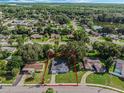 Aerial view of a single-Gathering home with a large backyard and neighborhood setting at 1609 Woodlyn Dr, Leesburg, FL 34748