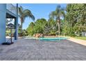 Relaxing pool area with a waterfall feature and spacious patio at 6048 Tremayne Dr, Mount Dora, FL 32757