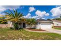 Single-story home with a covered porch and palm trees at 2630 Mcdonald Ter, Mount Dora, FL 32757