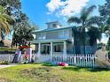 Two-story home with white picket fence and landscaping at 101 S Dixie Ave, Fruitland Park, FL 34731