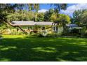 Ranch style home with a large green lawn at 17075 Se Highway 42, Weirsdale, FL 32195