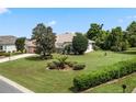 Single-story house with attached garage and nicely landscaped yard at 5500 Belle Terre Dr, Leesburg, FL 34748