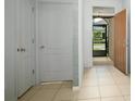 Light and airy entryway with tile floors and neutral colors at 3450 Landing Vw, Tavares, FL 32778