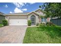 One-story home with attached garage and landscaped yard at 3450 Landing Vw, Tavares, FL 32778