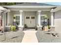 Inviting front porch with rocking chairs and stone accents at 16394 Se 89Th Ter, Summerfield, FL 34491