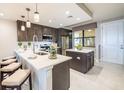 Modern kitchen with island, stainless steel appliances, and white countertops at 16300 County Road 455 # 604, Bella Collina, FL 34756