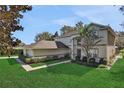 Two-story house with a gray exterior, brown roof, and landscaped yard at 24126 Plymouth Hollow Cir, Sorrento, FL 32776