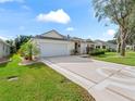 Driveway with decorative design leading to a house with a two-car garage at 7080 Se 173Rd Arlington Loop, The Villages, FL 32162