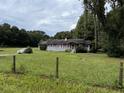 One-story house with purple shutters and a large yard at 11311 Se 132Nd Pl, Ocklawaha, FL 32179