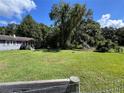 Spacious front yard with large trees and a grassy area at 11311 Se 132Nd Pl, Ocklawaha, FL 32179