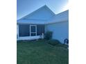 Side view of a light blue house with a screened porch at 104 Turtle Run, Umatilla, FL 32784