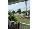 Quaint front porch with a view of the lake and neighborhood at 104 Turtle Run, Umatilla, FL 32784