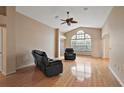 Living room with hardwood floors, vaulted ceiling and ceiling fan at 1401 Valparaiso St, The Villages, FL 32162