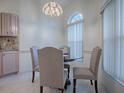 Cozy breakfast nook with a round table and four chairs at 1302 Oporto Dr, The Villages, FL 32162