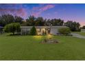 Single-wide home with landscaped yard at dusk at 8333 County Road 109A-1, Lady Lake, FL 32159