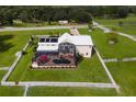 Aerial view of a home with a pool and screened enclosure at 39400 French Rd, Lady Lake, FL 32159