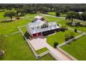 Aerial view of a large home with a metal roof, red doors, and a long driveway at 39400 French Rd, Lady Lake, FL 32159