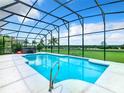 Inviting screened pool and hot tub with golf course views at 139 Belfry Dr, Davenport, FL 33897