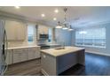 Modern kitchen with a large island, stainless steel appliances, and white cabinets at 38530 Wooded Meadow Drive, Umatilla, FL 32784