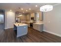 Modern kitchen with a large island, stainless steel appliances, and white cabinets at 38530 Wooded Meadow Drive, Umatilla, FL 32784